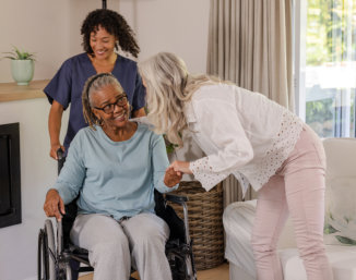 nurse and elderly man sitting on a chair