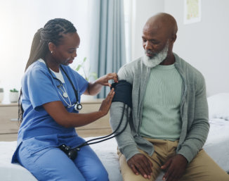 aide assisting the elderly woman man